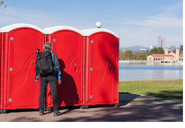 Portable restroom unit positioned at a remote lakefront property in San Diego County