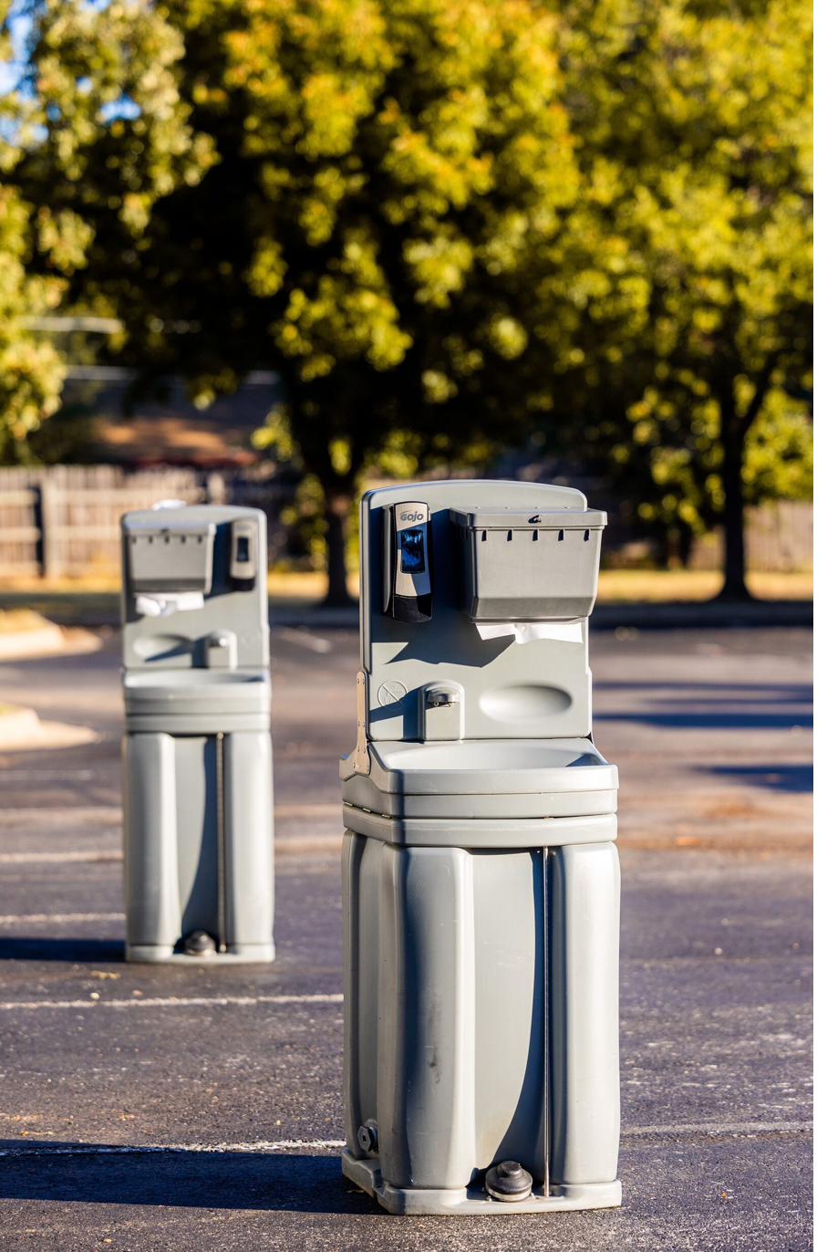 Fresh hygiene supplies being restocked at a portable hand wash station